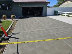 New concrete driveway, dark gray, with a circular sweat finish.