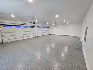 Finished garage with white walls and new epoxy on the garage floor.