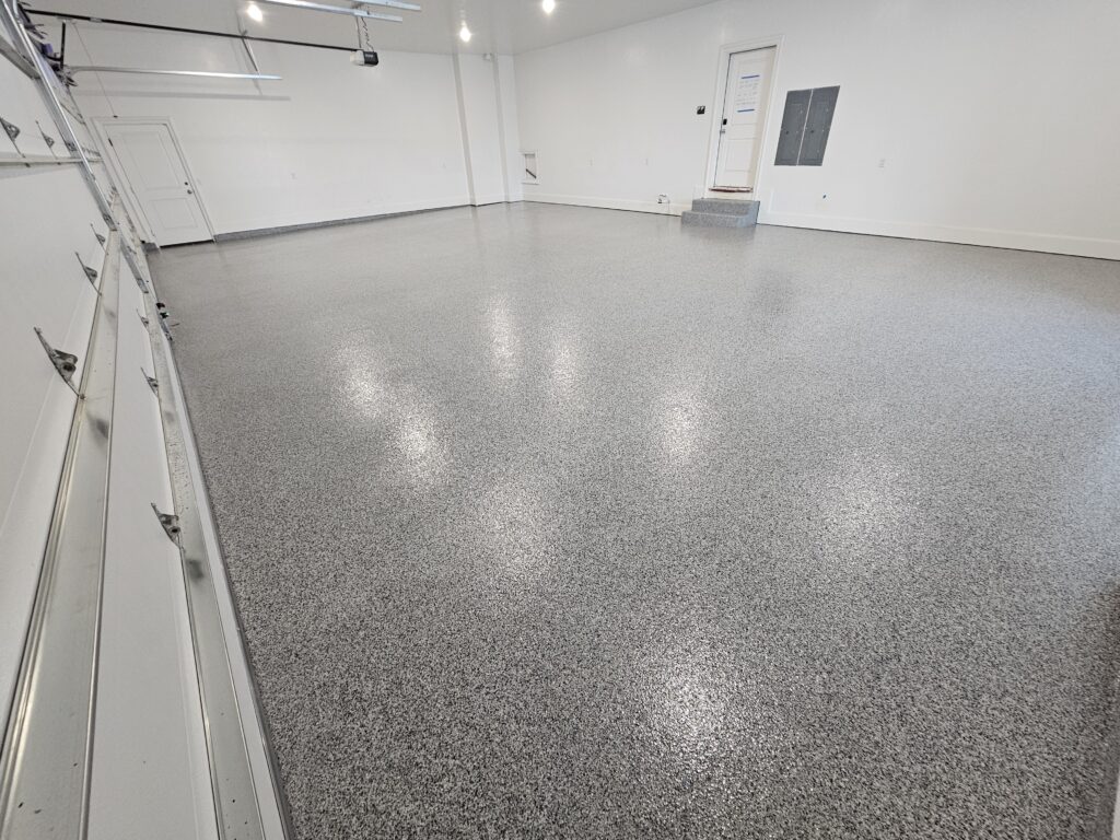 Finished garage with white walls and new epoxy on the garage floor.
