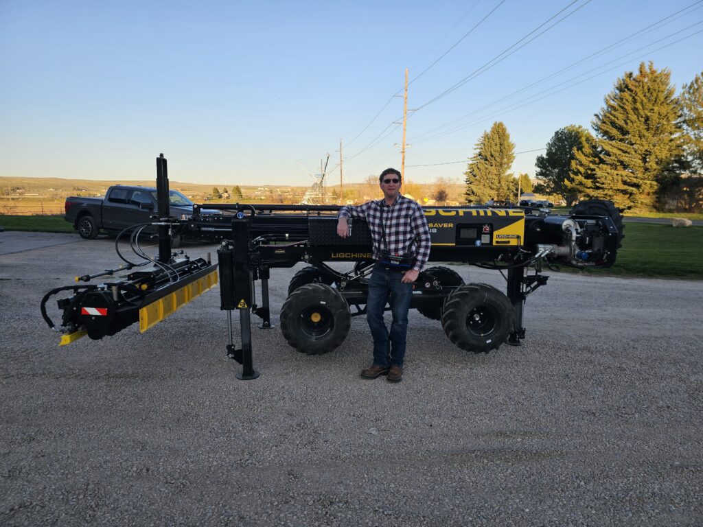 A well dressed man standing in front of a Ligchine Laser Screed. Offering super flat floors or one way slope. Screed for hire or finishing included.