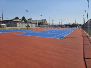 Repaired and resurfaced high school tennis courts. Out of bounds in Red and in bounds in tournament blue.